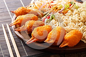 Crab claws breaded served with udon noodles and fresh vegetable