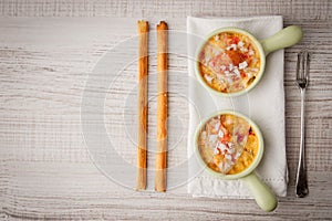 Crab cocotte with breadsticks and vintage fork on the white napkin horizontal