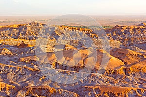 Crab-like colorful rocks at foreground and red crust over salt deposits of rock formations at high altitude in the desert spreadin