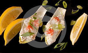 Crab salad on endive leaves with lemon