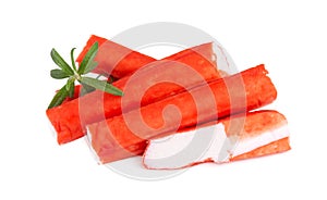 Crab stick isolated on white background. Imitation crab meat with rosemary sprig. Fish product