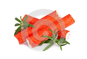 Crab stick isolated on white background. Imitation crab meat with rosemary sprig. Fish product