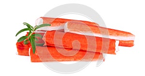 Crab stick isolated on white background. Imitation crab meat with rosemary sprig. Fish product