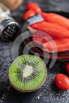 Crab stick put on a black plate on the black cement floor