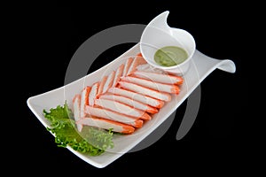 Crab stick with wasabi on black