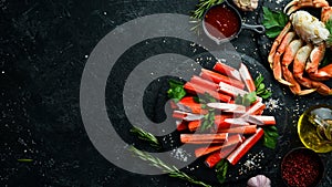 Crab sticks from a crab on a black stone plate.  Seafood delicacies