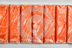 Crab sticks or imitation crab meat surimi in a package top view