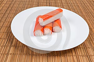 Crab sticks stuffed with cheese spread on a white dish