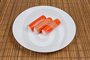 Crab sticks stuffed with cheese spread on a white dish