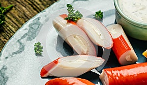 Crab sticks surimi on ceramic plate. Food recipe background. Close up