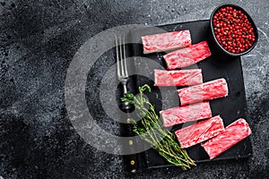 Crab surimi sticks on marble board. Black background. Top view. Copy space