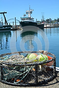 Crab trap and fishing boat Timmy Boy in Newport, Oregon photo