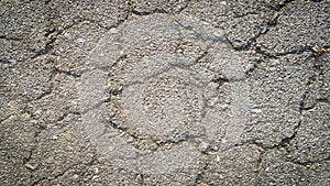 Crack on the asphaltic surface. Natural pattern on textured surface. Ruined of the walkway.