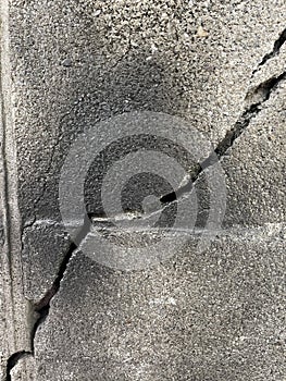 Crack background of old gray brick wall which is a relatively large crack