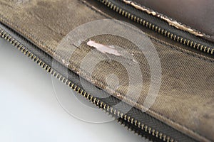 Crack of brown leatherette bag Damage due to lifetime
