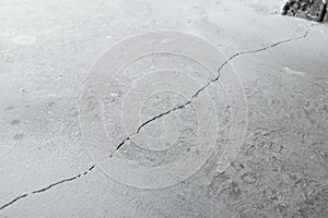 Crack in cement floor from shrinkage of house photo
