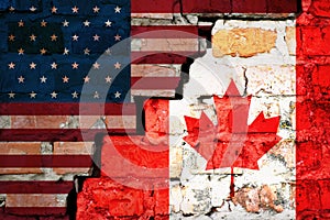 The crack between the flags of America and Canada closeup