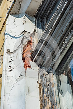 Crack in an old brick building and a vintage window, soft focus