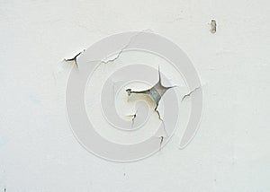 Cracked and aged white wall facade texture or background