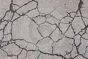 Cracked asphalt background. Old pavement texture with cracks.