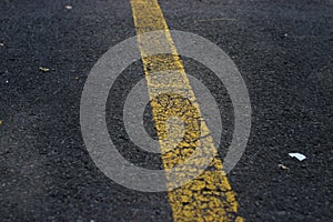 Cracked Asphalt background with yellow line