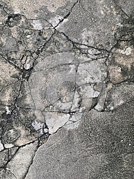 the cracked asphalt on the road