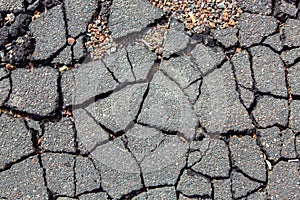 The cracked asphalt spoiled highway road.