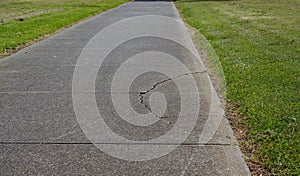 Cracked asphalt on walking path photo