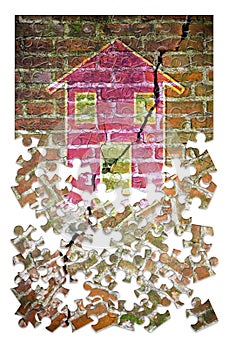 Cracked brick wall with a colored house drawn on it in puzzle shape - concept image