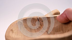 Cracked broken empty wooden dish with fracture in hand close up.