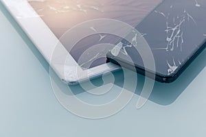 cracked or broken screen of smartphone and tablet on plain background