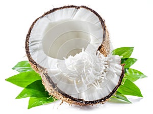 Cracked coconut fruit with white flesh and shredded coconut flakes isolated on white background