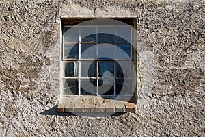 window in cracked and weathered wall outside photo