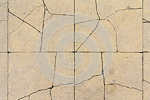 Cracked concrete tile texture. City pavement crack background. Abstract stone brick pattern. Street sidewalk texture