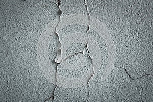 Cracked concrete wall covered with gray cement texture as background for design