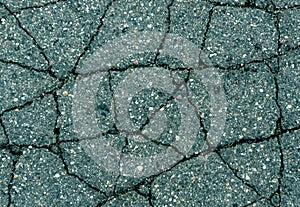 Cracked cyan asphalt surface.