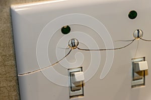Cracked and damaged light switch wall plate
