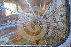 The cracked and damaged rear window of an antique panel truck