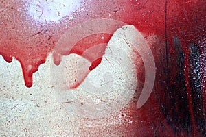 Cracked and dripping red and white paint on grunge metal