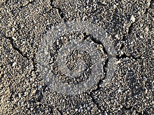 Cracked dry ground mud, dried under sun road.