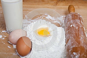 Cracked egg, flour and milk for baking christmas cookies