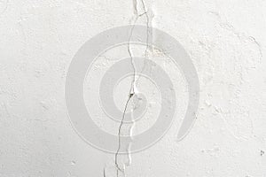 Cracked flaking white paint on the wall texture background.