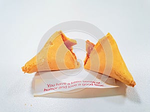 Cracked fortune cookie with a positive message