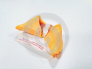 Cracked fortune cookie with a positive message