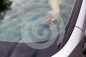 Cracked front windshield after stone chip on the road