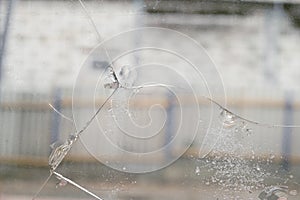 Cracked glass with chips caused by shrinkage of building structures photo