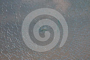 Cracked glass of milk color. Damaged glass structure in the terr