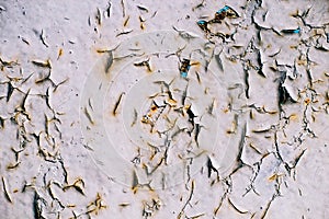 Cracked gray paint on an old metallic surface, rusted gray painted metal wall, sheet of rusty metal with cracked and flaky paint