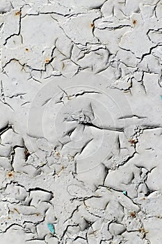 cracked gray paint on an old metallic surface, rusted gray paint