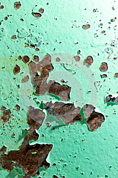 Cracked green paint on rusty metal as abstract background